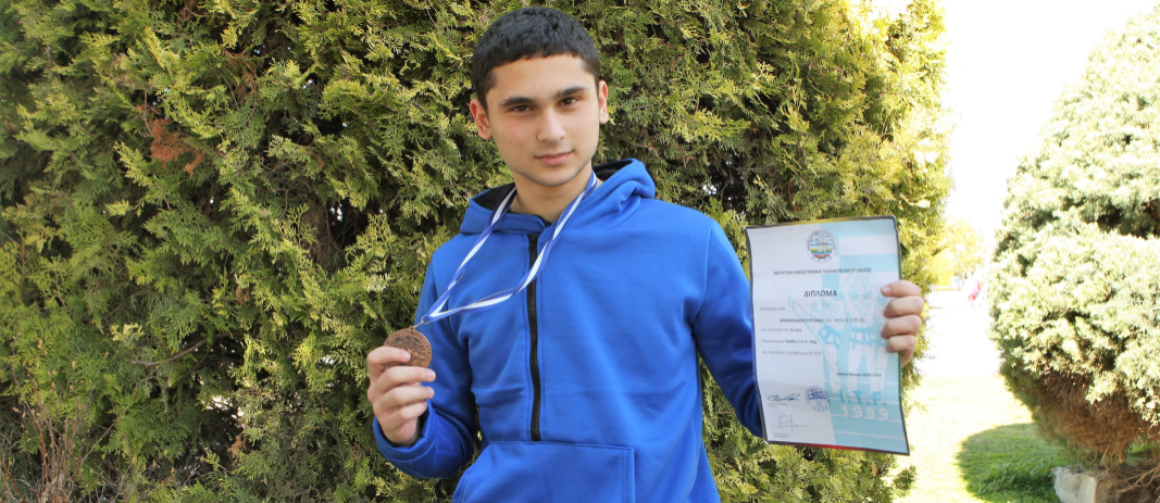 kid in blue wearing Bronze medal in the Panhellenic Tae Kwon Do championship